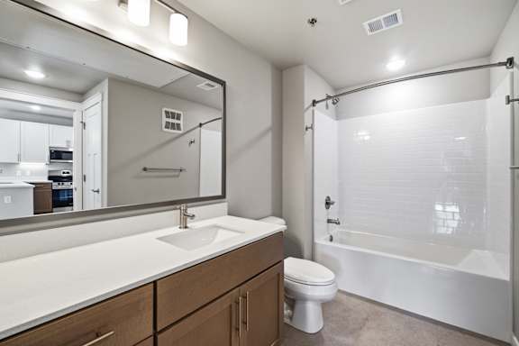 A bathroom with a sink, toilet, and bathtub.