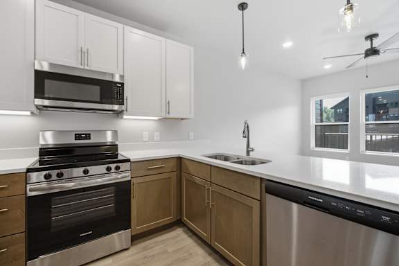 A modern kitchen with a stainless steel oven and microwave.