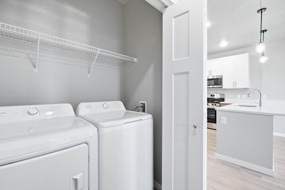 A white laundry room with a washer and dryer.