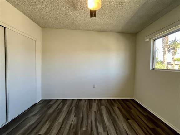 A room with wooden floors and a window.