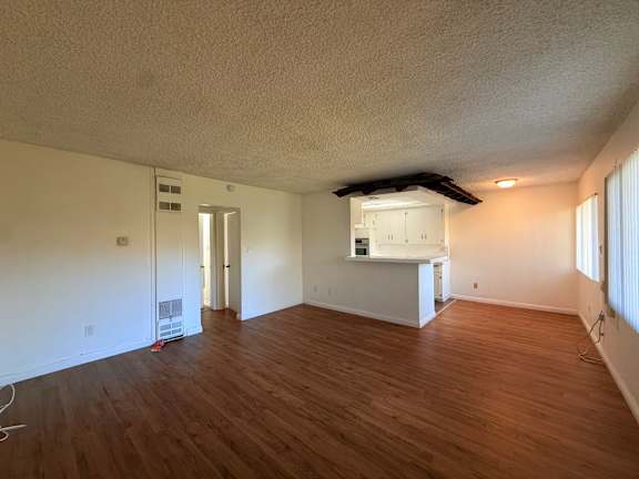 A room with wooden floors and white walls.
