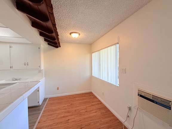 A room with a window and a radiator on the wall.