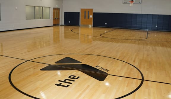 A basketball court with a logo on the floor that says "the".