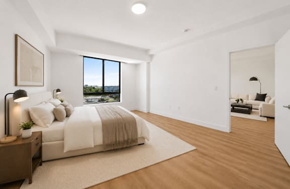 A bedroom with a large bed and a view of the city.