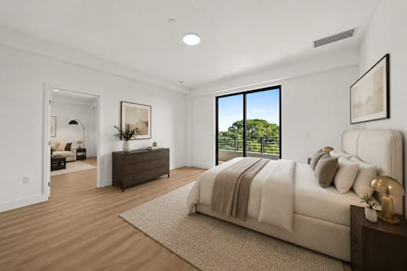 A bedroom with a large bed and a dresser with a mirror.