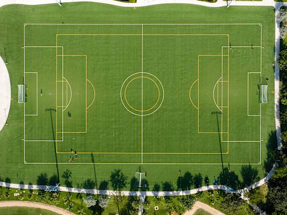 A soccer field with players on it.