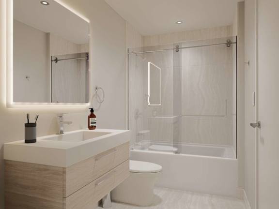 A modern bathroom with a white toilet and a white sink.