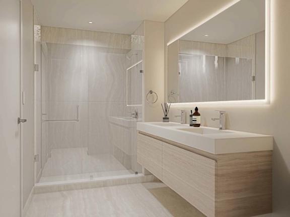 A modern bathroom with a walk-in shower and double sink vanity.