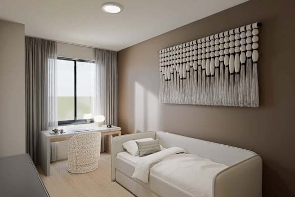 A modern bedroom with a large bed and a desk with a chair.