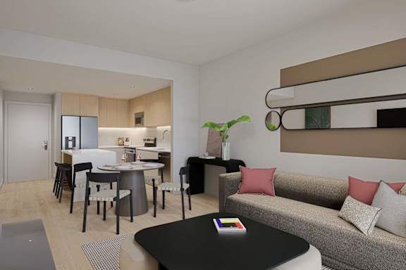 A living room with a grey couch and a black coffee table.