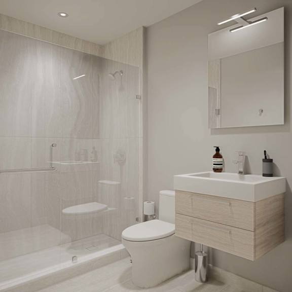 A white toilet sits next to a sink in a modern bathroom.