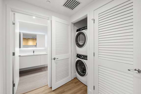 A white laundry room with a washer and dryer.