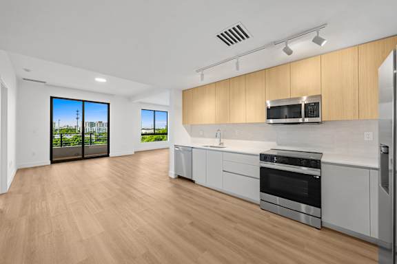 A modern kitchen with wooden cabinets and stainless steel appliances.