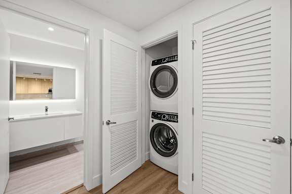 A white laundry room with a washer and dryer in it.