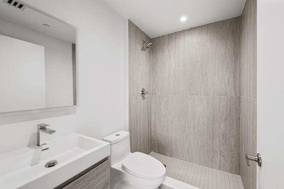 A white toilet sits next to a sink in a bathroom.