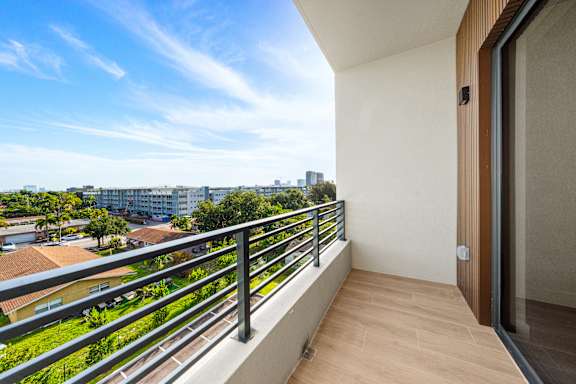 A balcony with a view of a residential area.