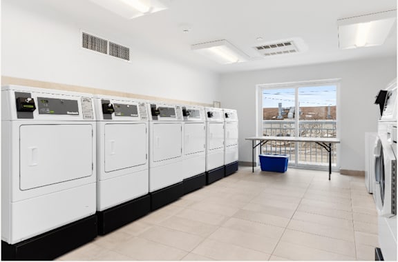 A row of washing machines in a laundromat.
