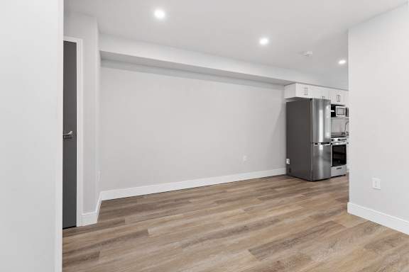A kitchen area with a refrigerator and a dishwasher.