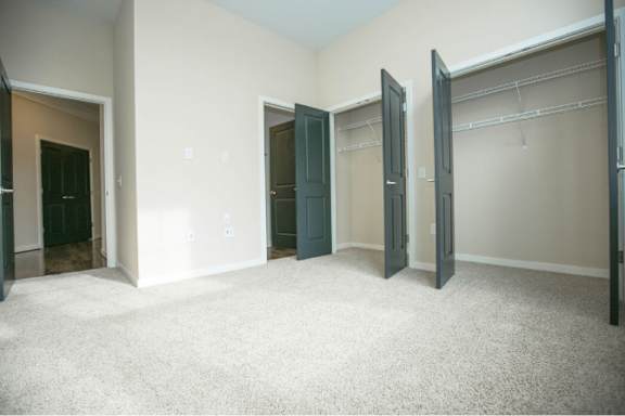 A room with a carpeted floor and a white wall.