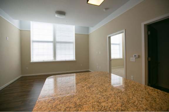 A room with a brown floor and a window.
