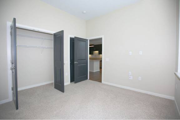 A room with a sliding door and a black cabinet.