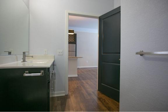A bathroom with a sink and a black cabinet.