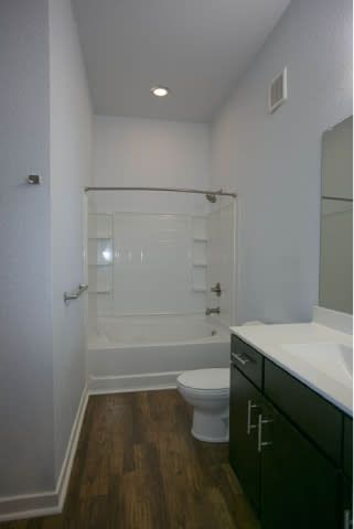 A bathroom with a toilet, sink, and shower.