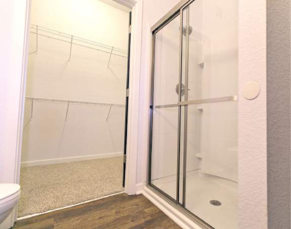 A white bathroom with a walk in shower.