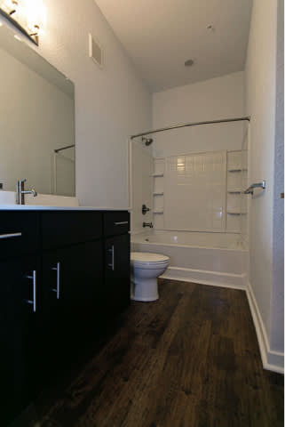 A bathroom with a toilet, sink, and a walk-in shower.