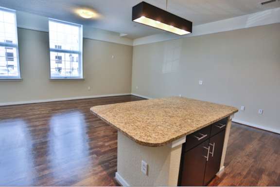 A room with a counter and cabinets.