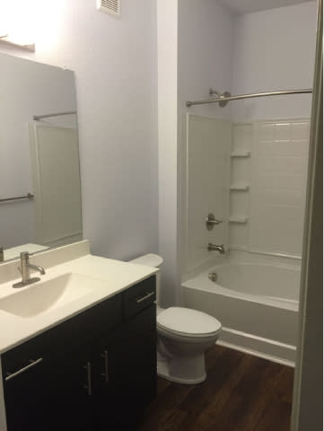 A white toilet sits next to a sink in a bathroom.