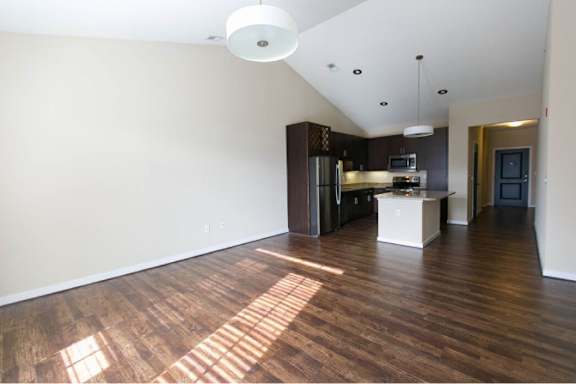 A kitchen with wooden floors and a white ceiling.