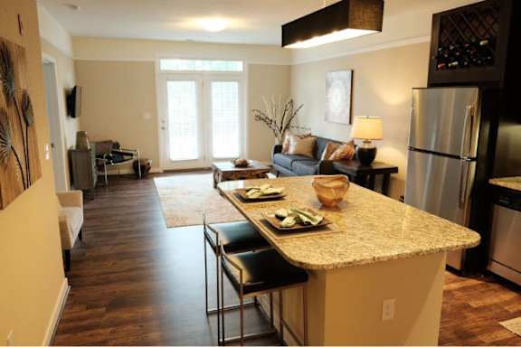 A kitchen with a table and chairs in the middle of the room.