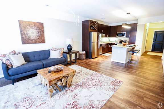 A living room with a blue couch and a coffee table.