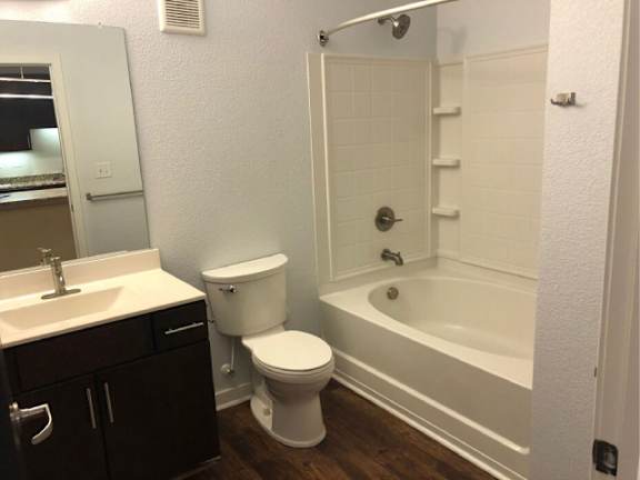 A white toilet sits next to a sink in a small bathroom.