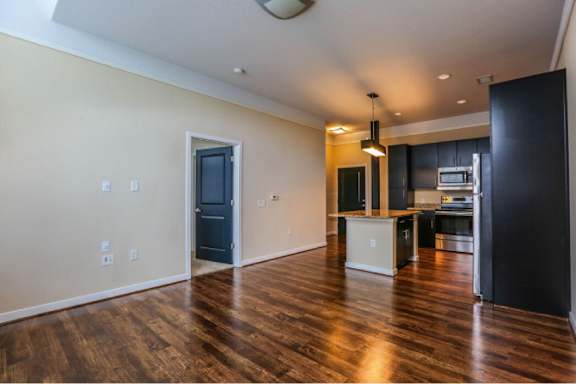 A kitchen area with a refrigerator, microwave, and oven.