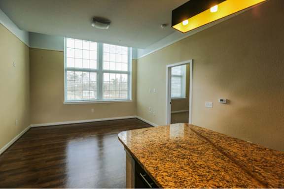 A room with a brown counter top and a window.