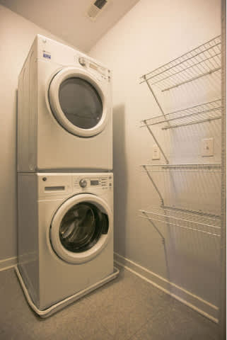 A stacked washer and dryer in a laundry room.