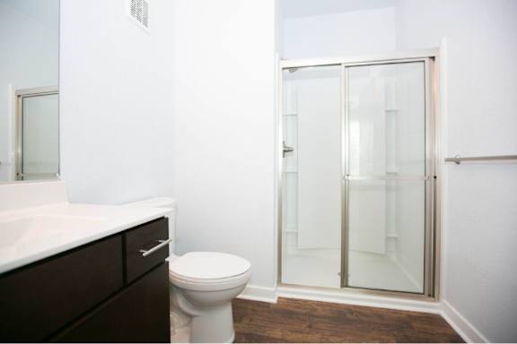A white toilet sits next to a sink in a bathroom.