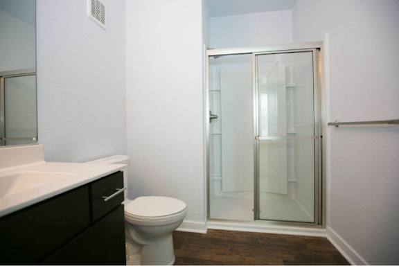 A white toilet sits next to a sink in a bathroom.