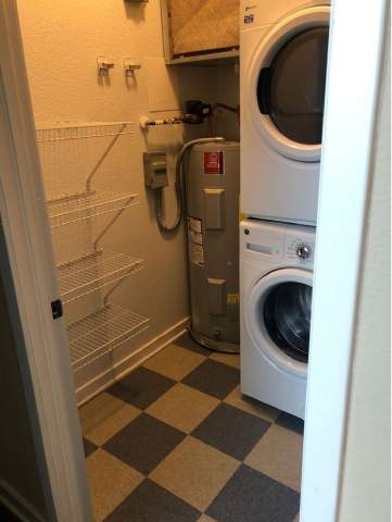 A small laundry room with a washer and dryer.