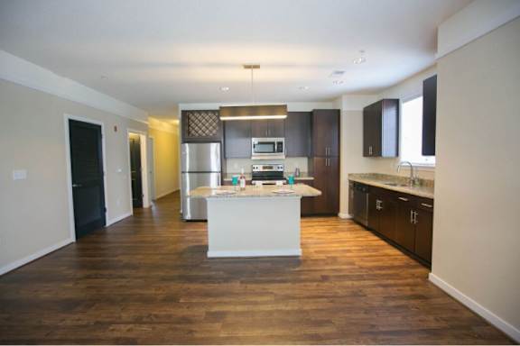 A kitchen with a white island in the middle of the room.