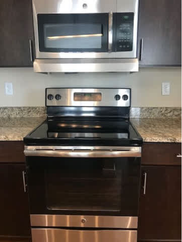 A stainless steel oven with a microwave above it.