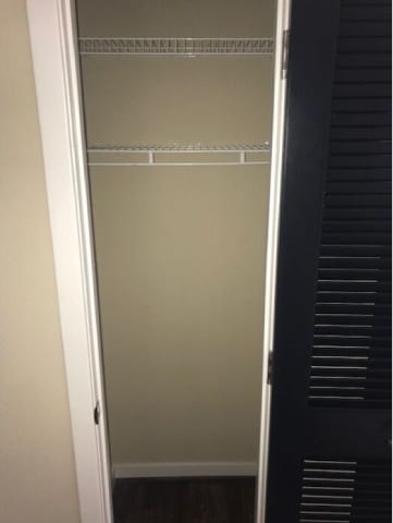 A black refrigerator with the door open.