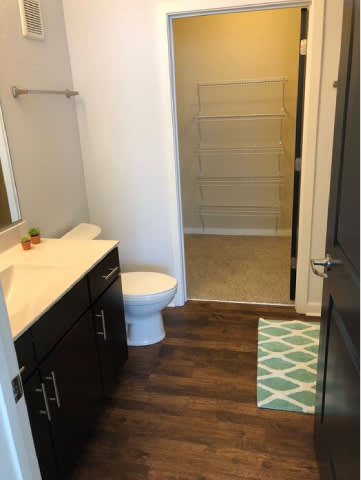 A bathroom with a white toilet and a walk in shower.