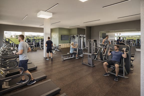A gym with people exercising and a sign that says