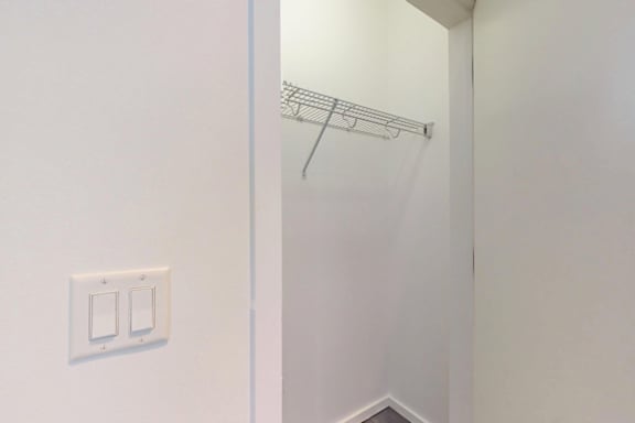 A white light switch is on a white wall.