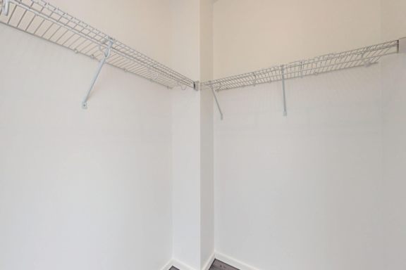 A white wall with a metal rack on it.