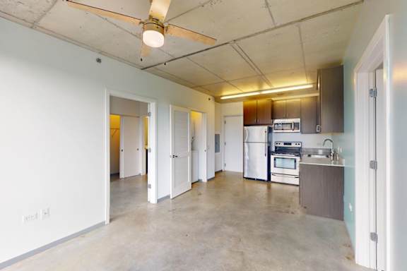 A kitchen with a stove top oven and a refrigerator.
