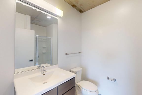 A white sink with a mirror above it.